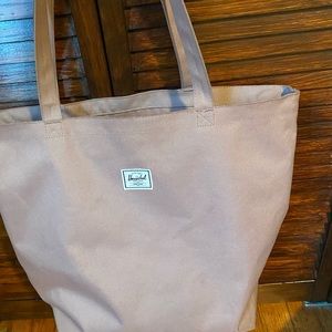 Herschel bag- mauve-y kind of pinkish color - has zipper closure on top